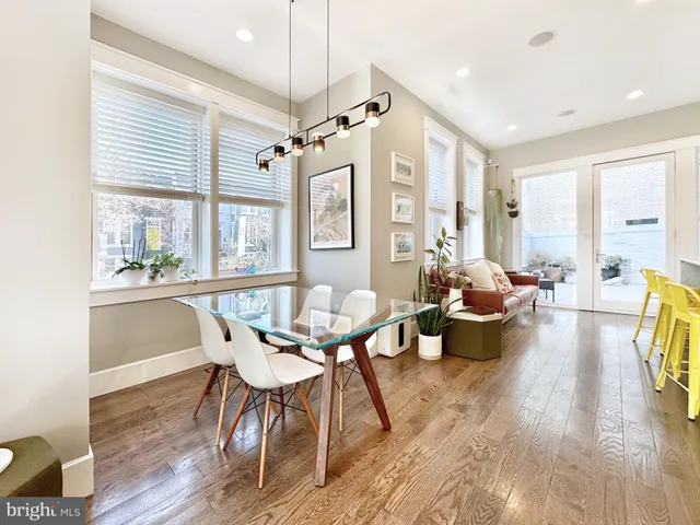 a view of a dining room with furniture a chandelier and wooden floor