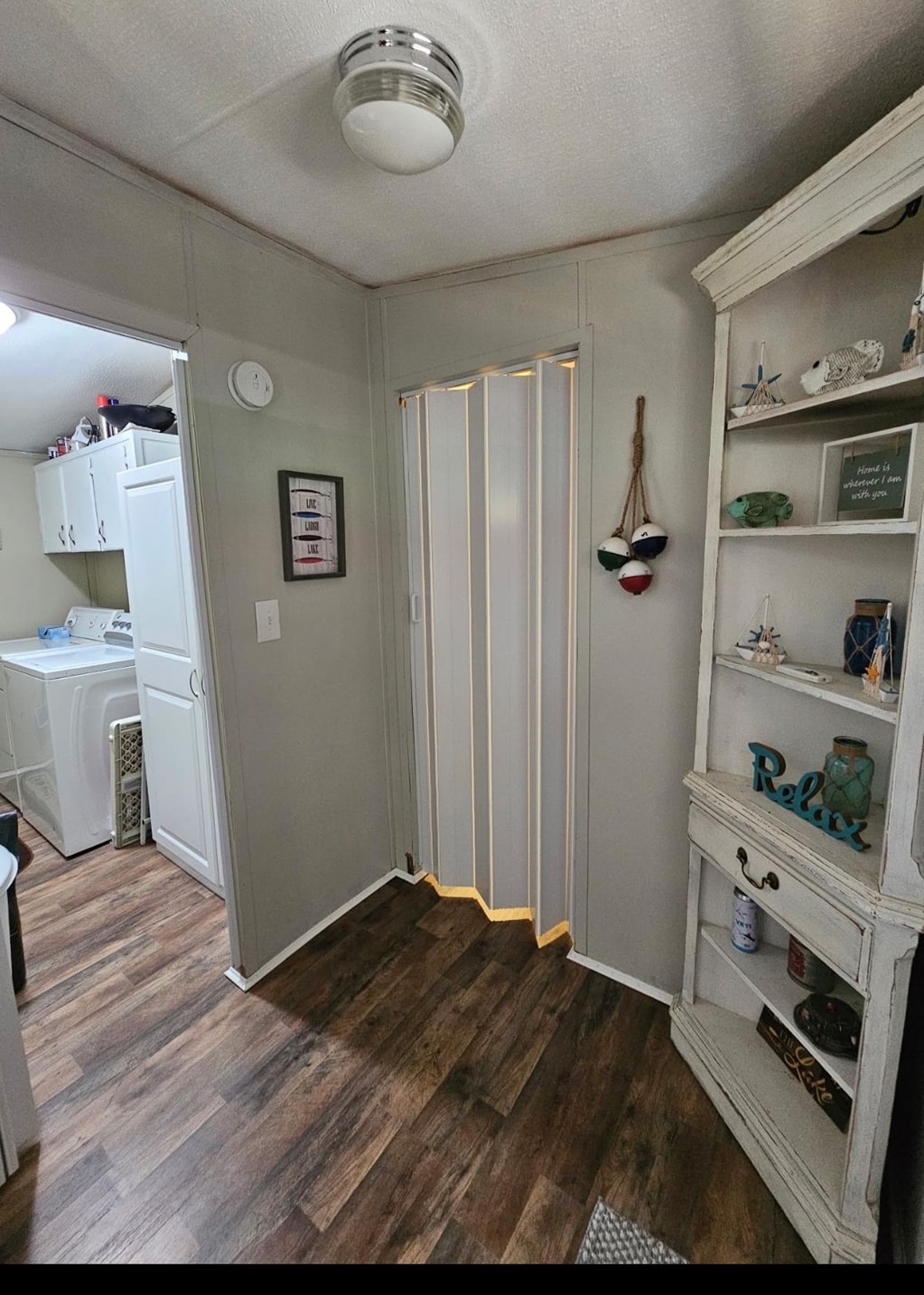 390 Wharf Road Savannah, TN 38372 - Photo 9 of 17 Wood-finish flooring throughout, complemented by light gray wall paneling