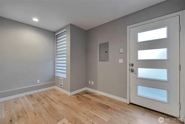 an empty room with mirror and windows