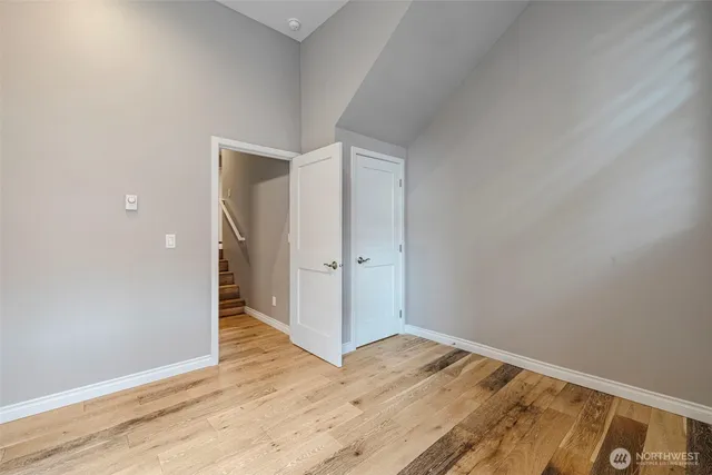 a view of a room with wooden floor