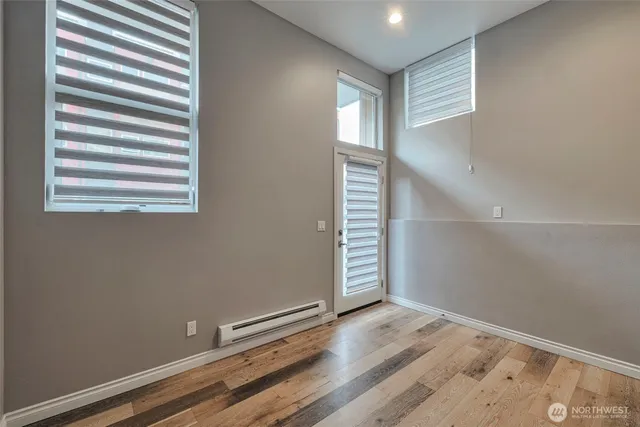 a view of a room with wooden floor and window