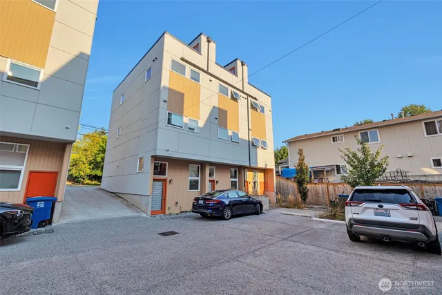 a couple of cars parked in front of a house