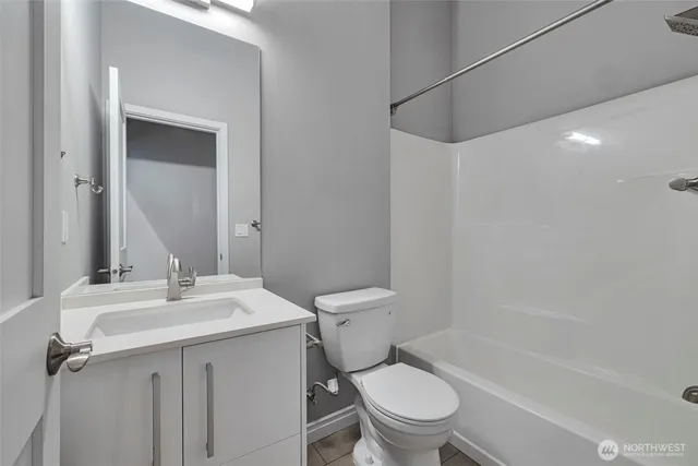 a bathroom with a sink toilet vanity and shower