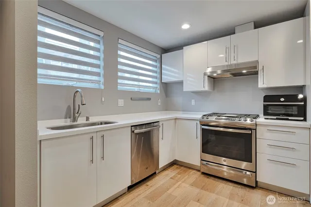 a kitchen with cabinets appliances and a sink