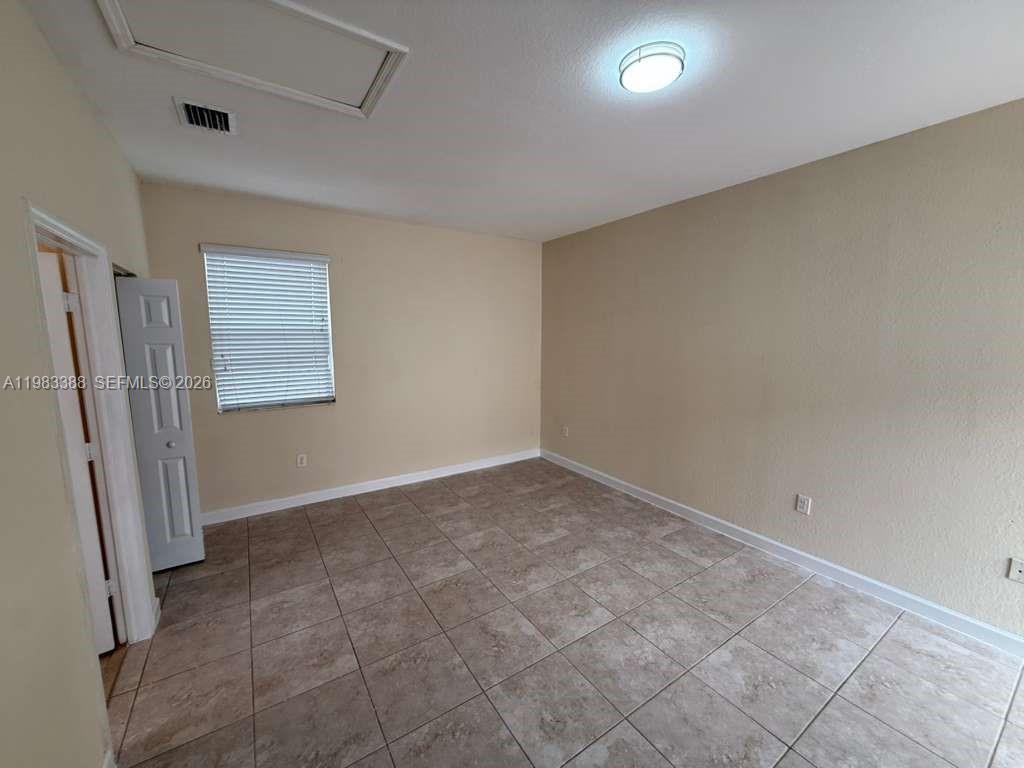 16735 Southwest 95th Street, Unit STUDIO Miami, FL 33196 - Photo 2 of 9 an empty room with windows