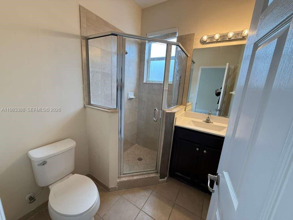 16735 Southwest 95th Street, Unit STUDIO Miami, FL 33196 - Photo 3 of 9 a bathroom with a toilet a sink and shower