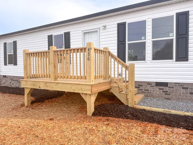 a view of front door of house with staircase