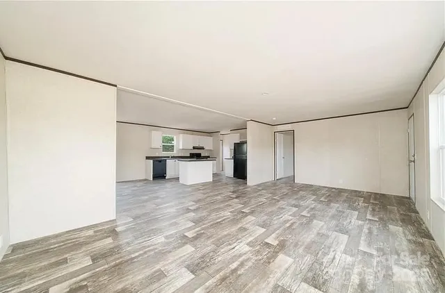 a view of a kitchen with a sink and a refrigerator