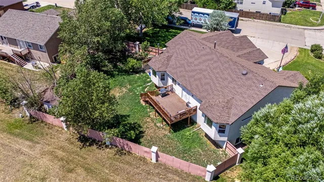 an aerial view of a house with garden space and street view