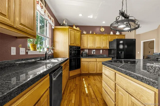 a kitchen with stainless steel appliances granite countertop a sink stove and cabinets