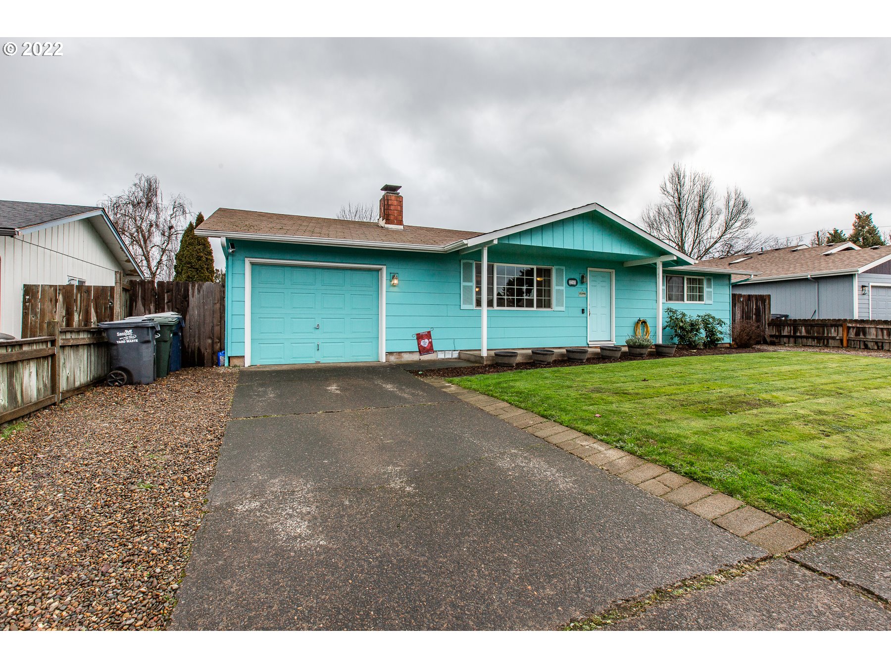 2265 10th Street Springfield, OR 97477 - Photo 1 of 23 a view of a house with a yard and large trees