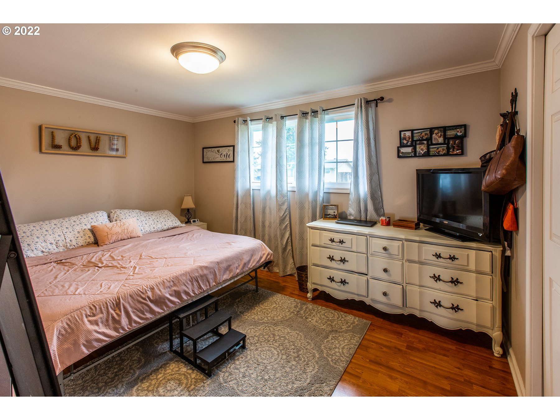 2265 10th Street Springfield, OR 97477 - Photo 17 of 23 a bedroom with a bed and a flat screen tv