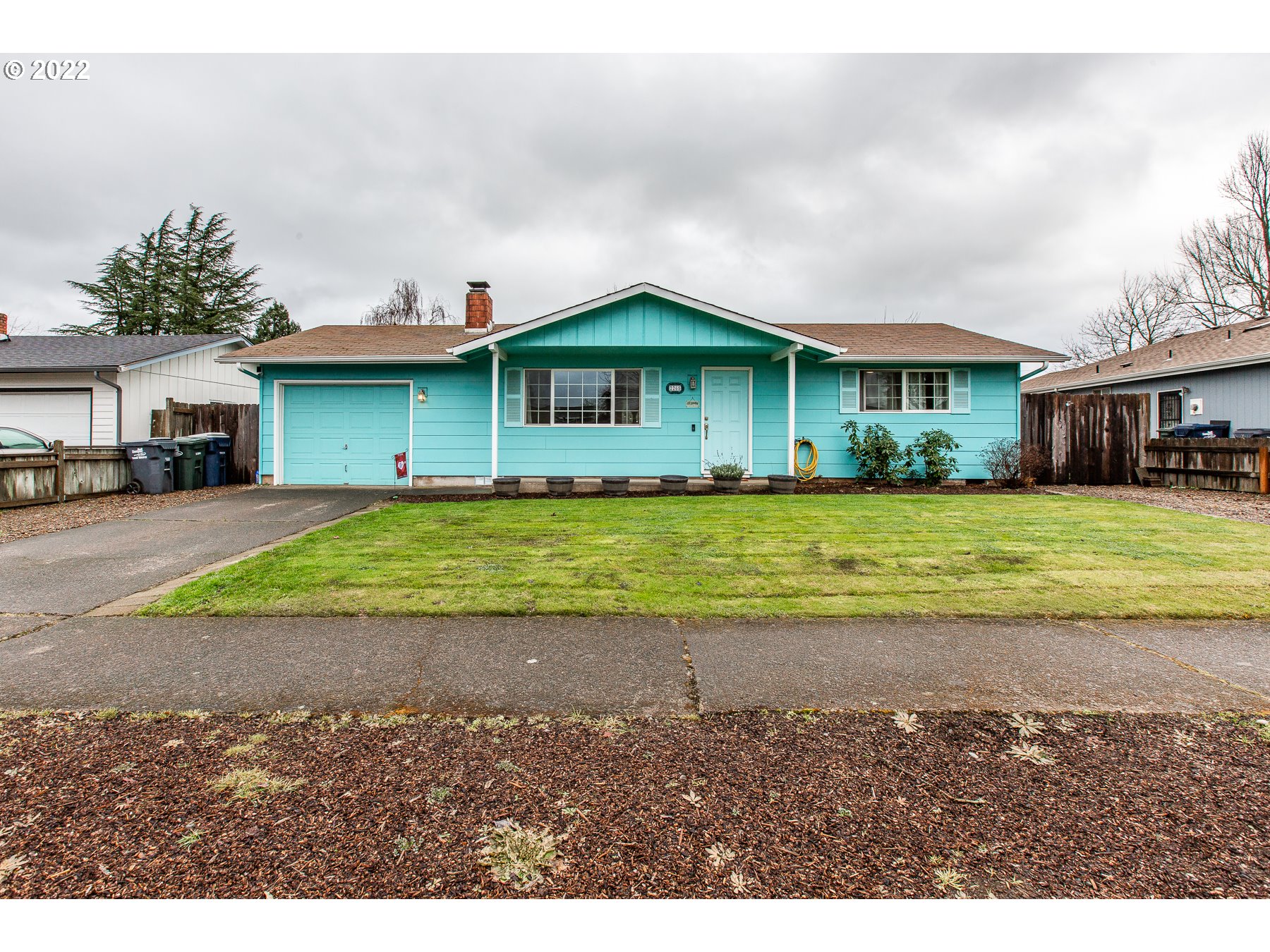 2265 10th Street Springfield, OR 97477 - Photo 2 of 23 a view of a house with a yard and potted plants