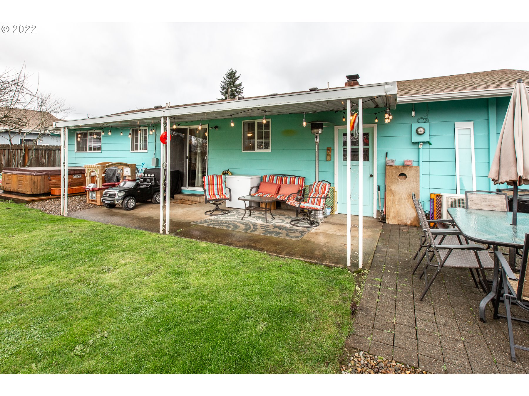 2265 10th Street Springfield, OR 97477 - Photo 21 of 23 a view of a patio with table and chairs and potted plants