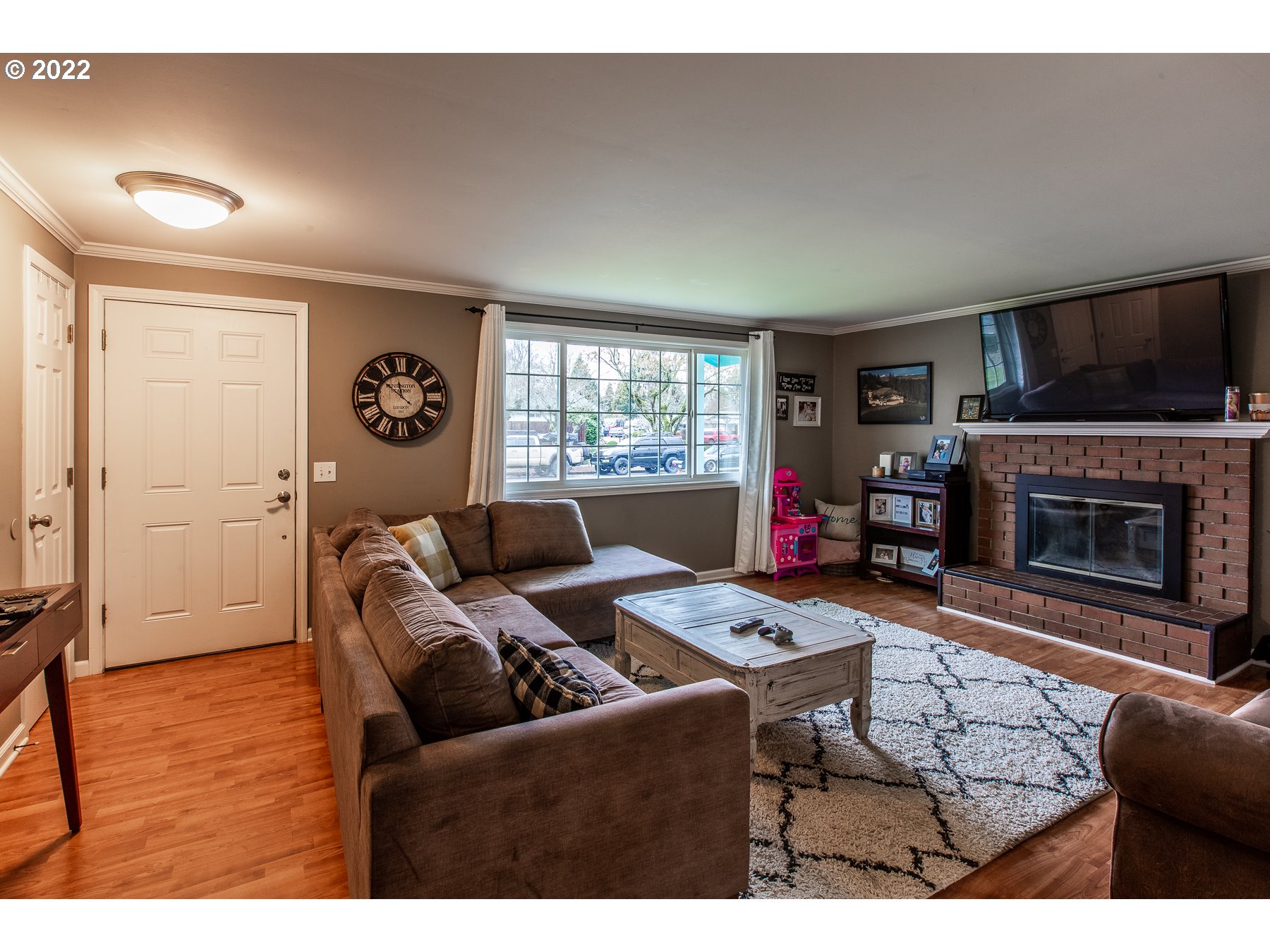2265 10th Street Springfield, OR 97477 - Photo 5 of 23 a living room with furniture a flat screen tv and a fireplace