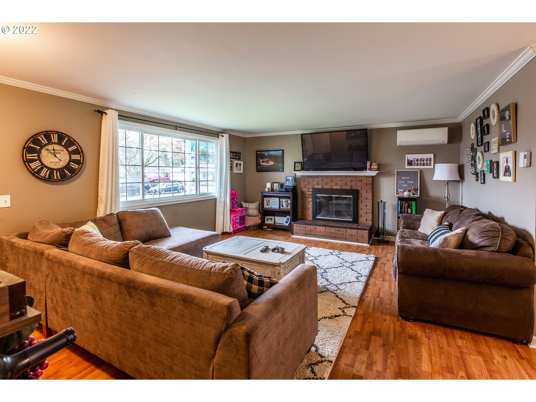 2265 10th Street Springfield, OR 97477 - Photo 6 of 23 a living room with furniture a flat screen tv and a fireplace