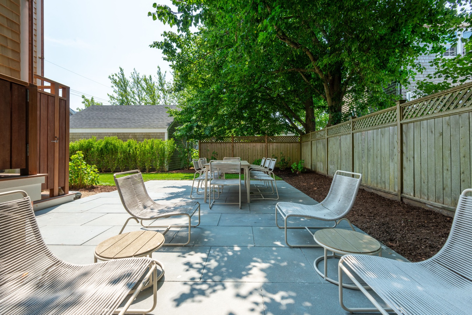 12 Willard Street Nantucket, MA 02554 - Photo 35 of 36 a view of a chairs and table in backyard