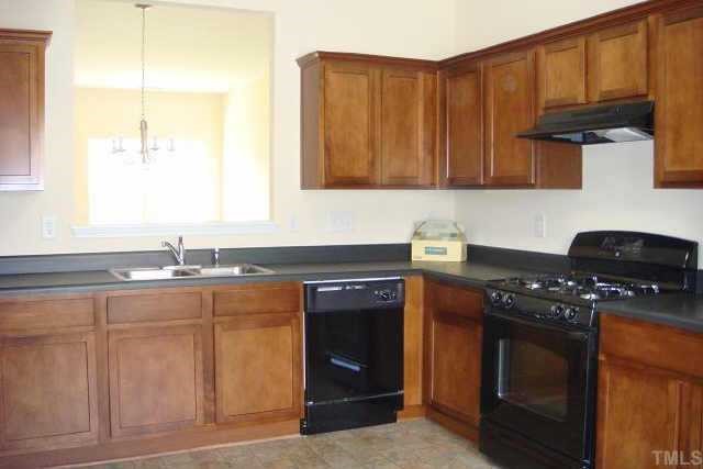 3527 Oneonta Avenue Raleigh, NC 27604 - Photo 4 of 6 a kitchen with stainless steel appliances granite countertop a stove a sink and a microwave