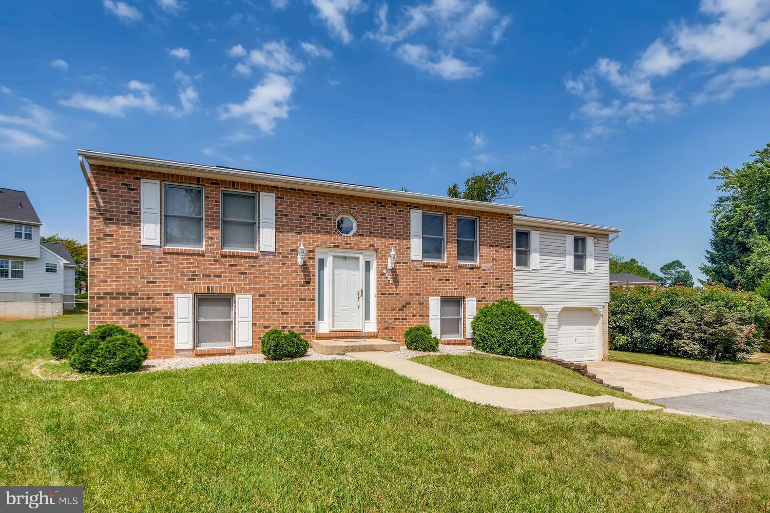 4628 Old Court Road Baltimore, MD 21208 - Photo 1 of 28 a front view of a house with a yard and garage