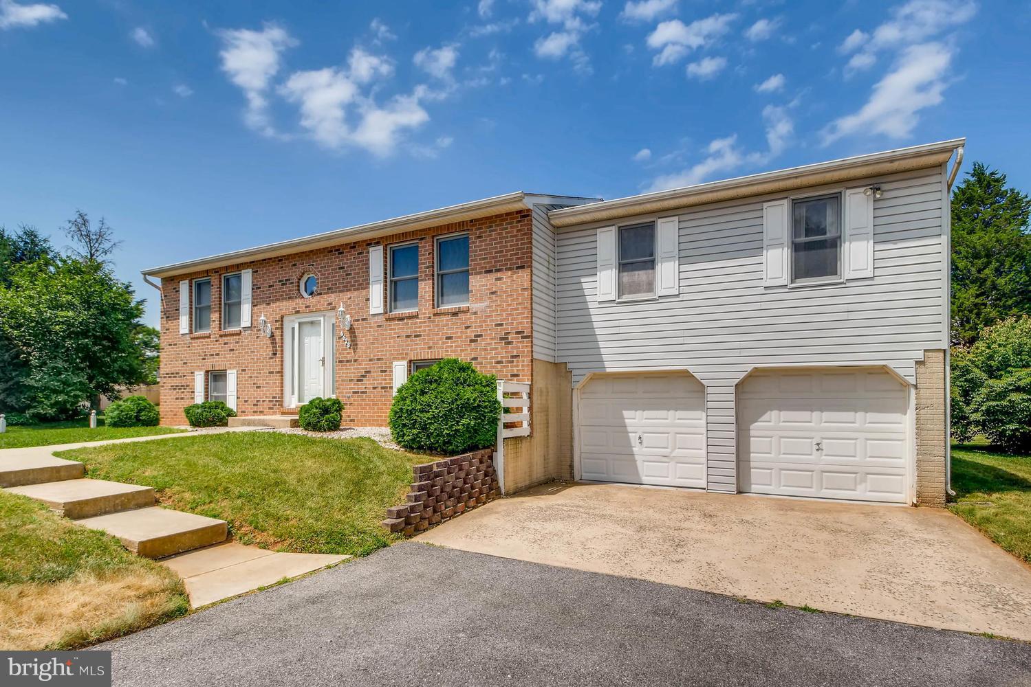 4628 Old Court Road Baltimore, MD 21208 - Photo 2 of 28 a front view of a house with a yard and garage