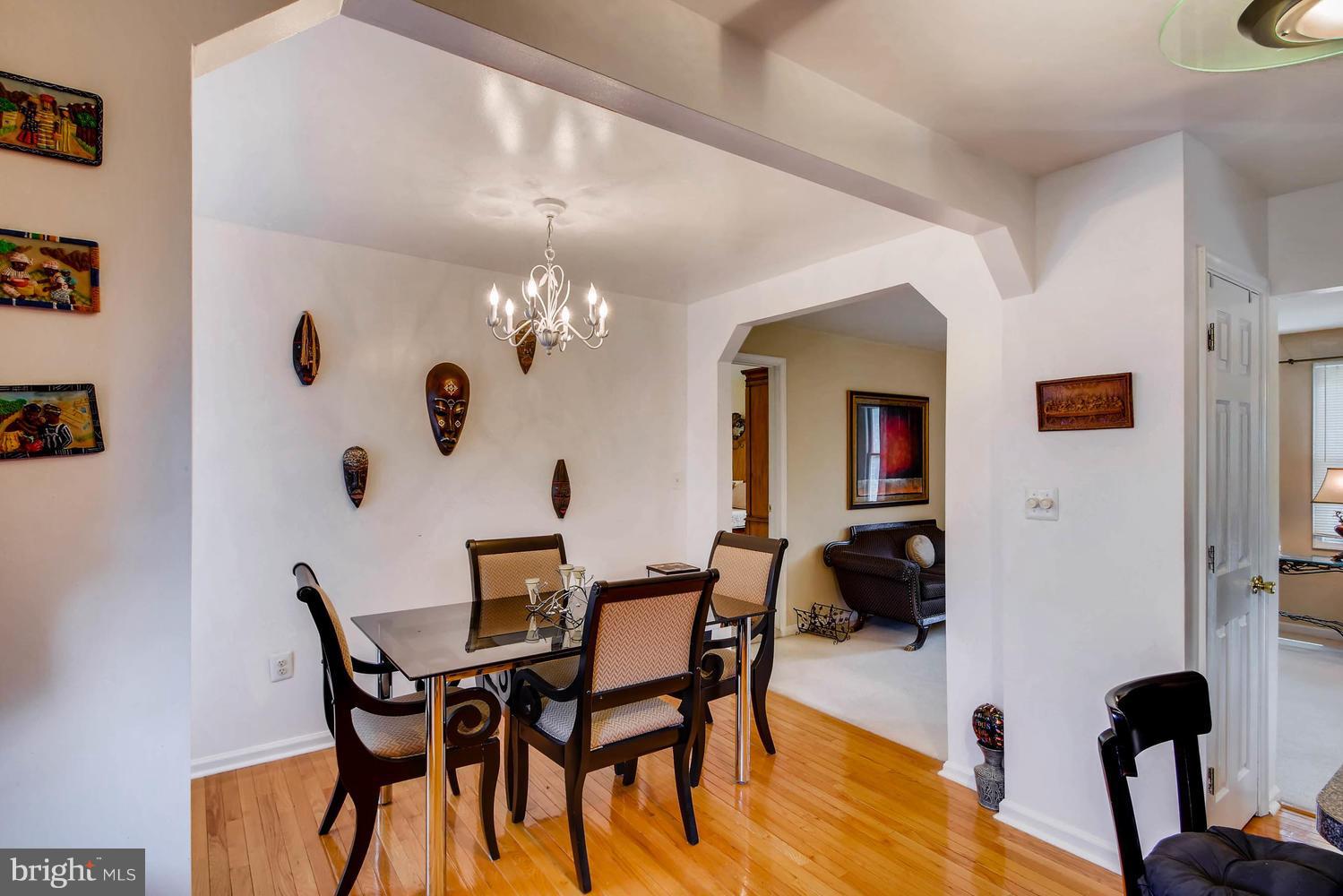 4628 Old Court Road Baltimore, MD 21208 - Photo 12 of 28 a view of a dining room with furniture and chandelier