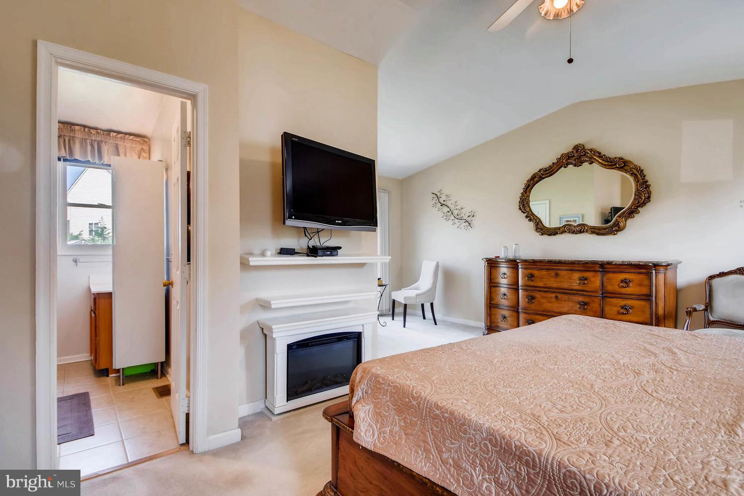 4628 Old Court Road Baltimore, MD 21208 - Photo 14 of 28 a bedroom with a bed and a flat screen tv