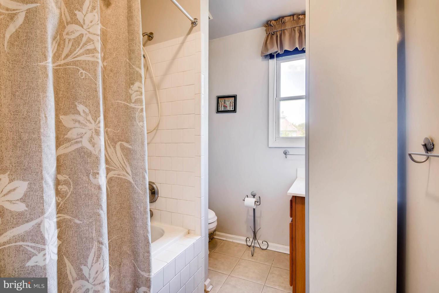 4628 Old Court Road Baltimore, MD 21208 - Photo 16 of 28 a bathroom with a bathtub and shower
