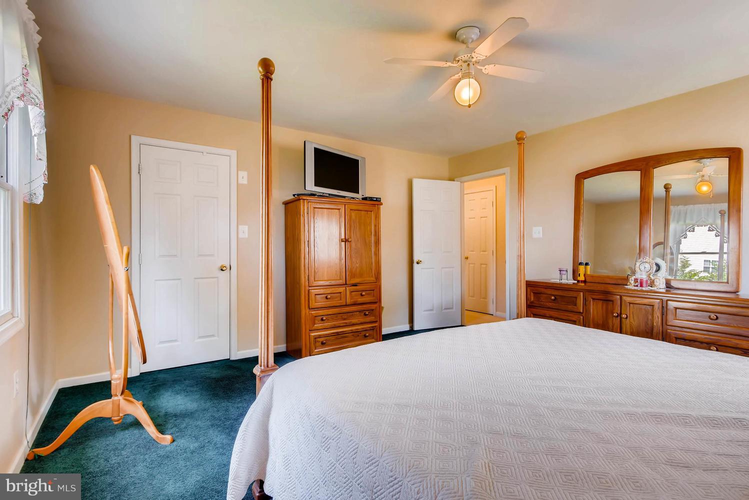 4628 Old Court Road Baltimore, MD 21208 - Photo 18 of 28 a bedroom with a bed and a chandelier