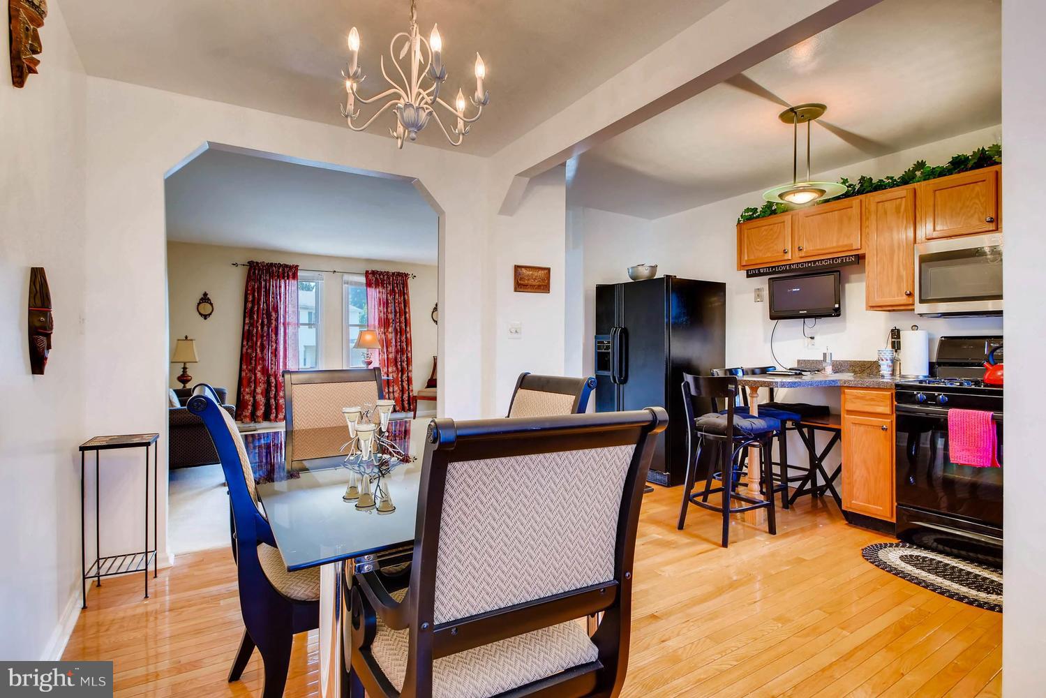 4628 Old Court Road Baltimore, MD 21208 - Photo 8 of 28 a dining room with furniture a chandelier and wooden floor