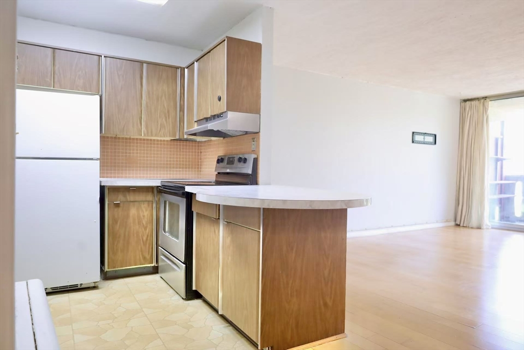 200 Swanton Street, Unit 237 Winchester, MA 01890 - Photo 3 of 14 a kitchen with stainless steel appliances a refrigerator and a stove