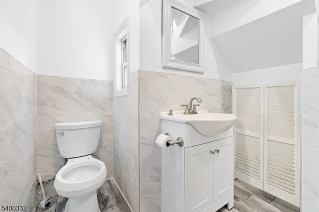 a bathroom with a sink a toilet and a mirror