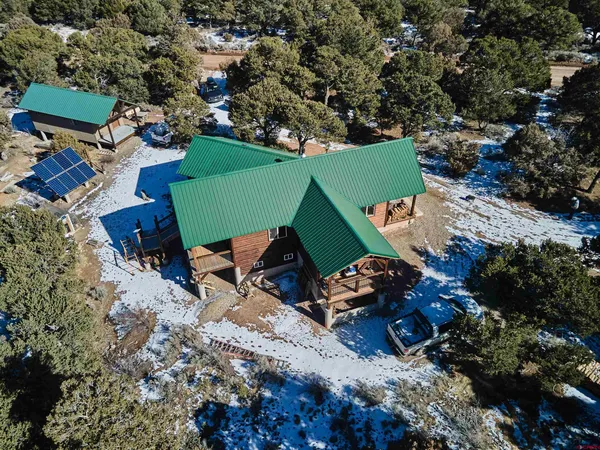 an aerial view of a house with a yard and lake view
