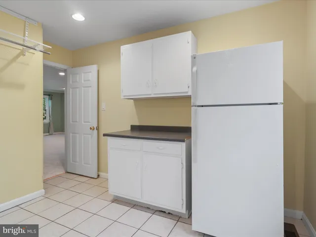 a utility room with cabinets washer and dryer