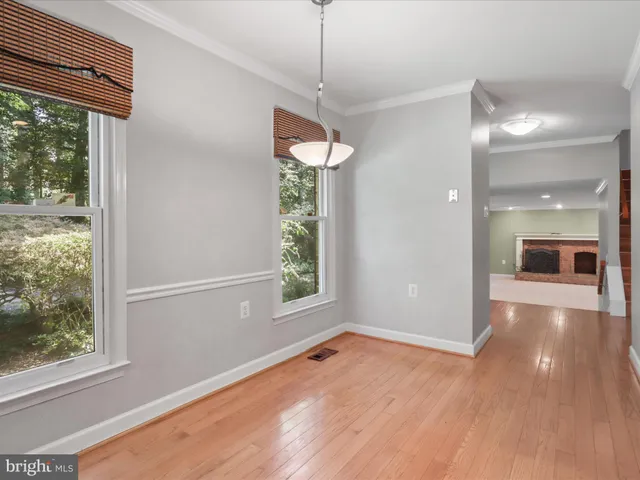 a view of a room with wooden floor and windows