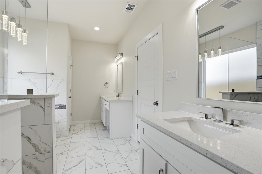 532 Highview Court Godley, TX 76044 - Photo 18 of 39 Spacious bathroom featuring white stone-finish flooring, dual vanities with integrated sinks, and quartz countertops