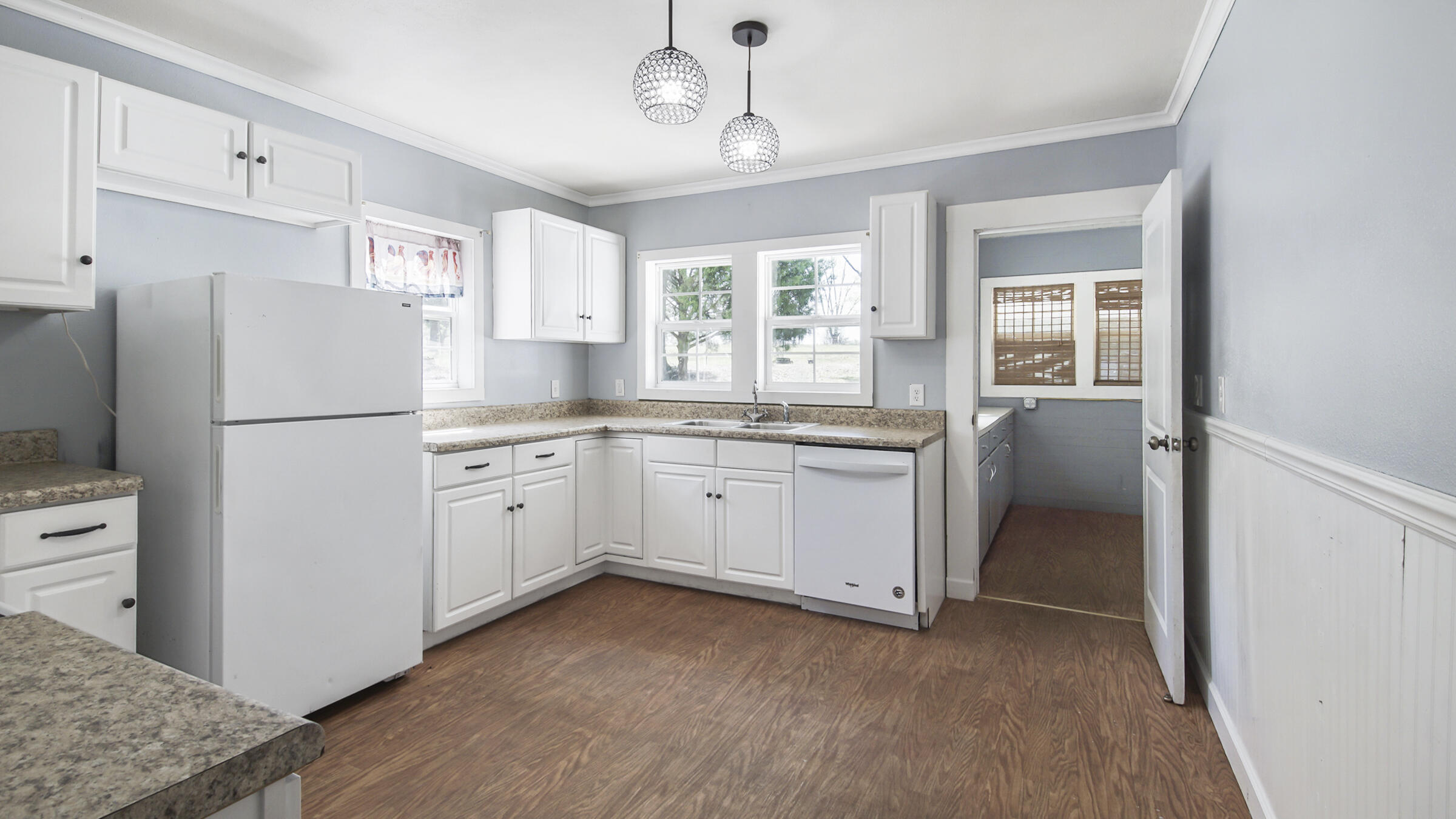 36 Williams Road DeFuniak Springs, FL 32433 - Photo 17 of 40 a kitchen with white cabinets and white appliances
