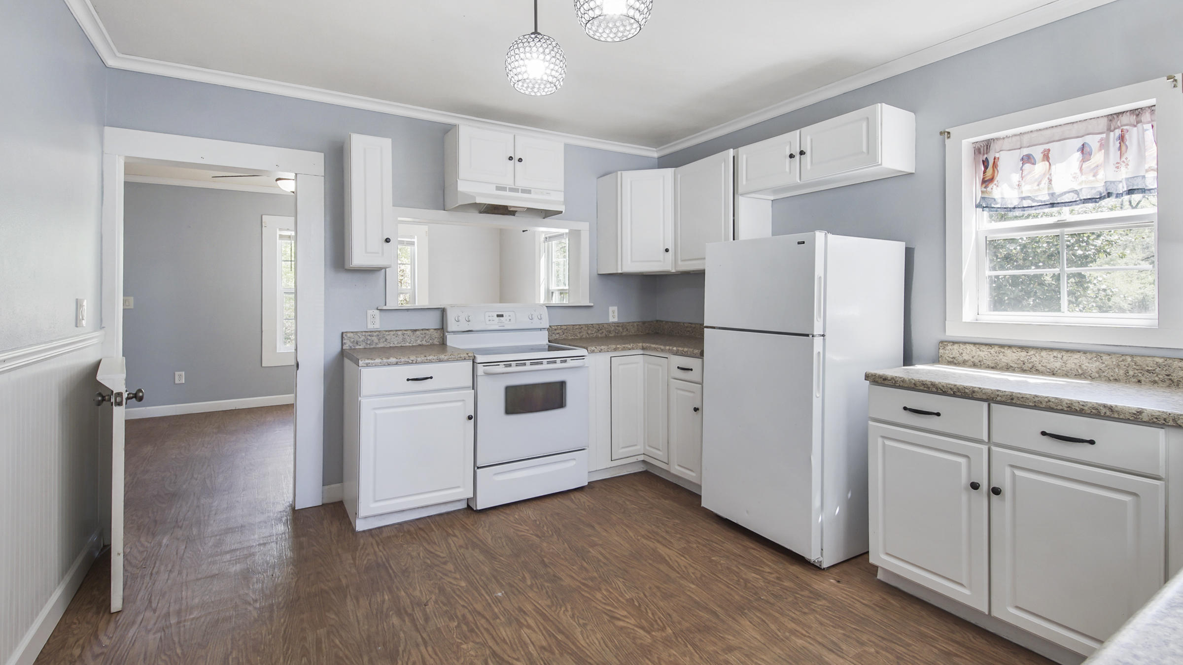 36 Williams Road DeFuniak Springs, FL 32433 - Photo 18 of 40 a kitchen with white cabinets and white stainless steel appliances
