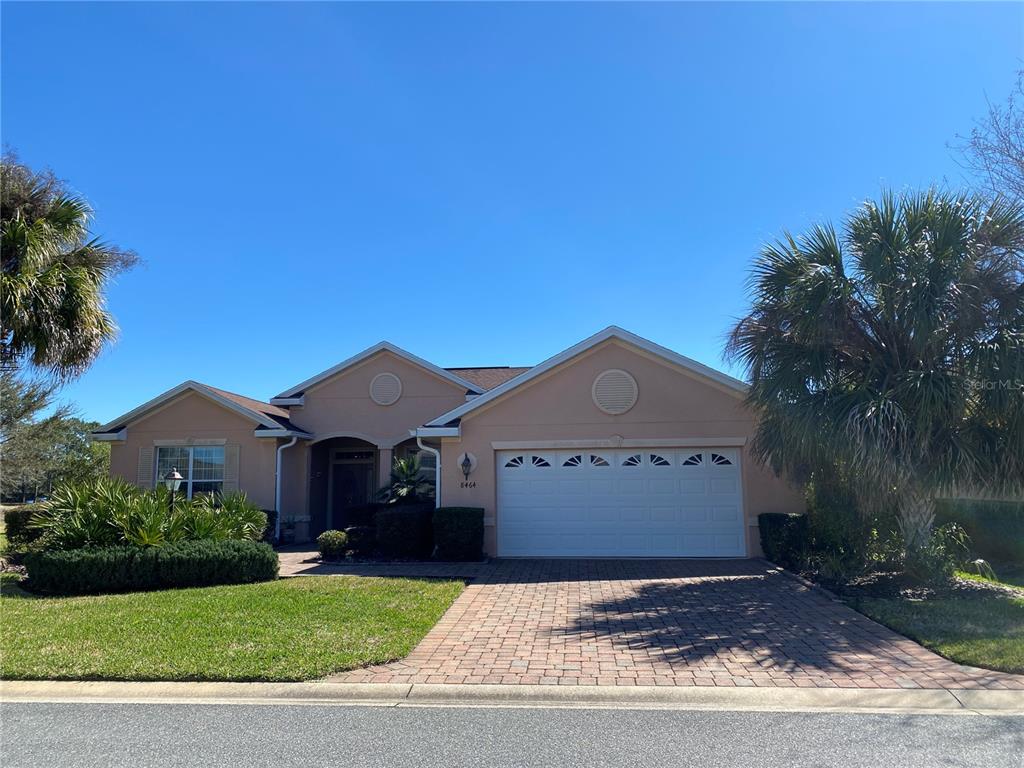 8464 Southwest 82nd Circle Ocala, FL 34481 - Photo 1 of 47 a front view of a house with a yard and garage