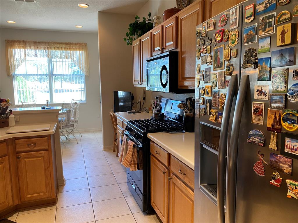 8464 Southwest 82nd Circle Ocala, FL 34481 - Photo 13 of 47 a kitchen with stainless steel appliances granite countertop a refrigerator and a stove