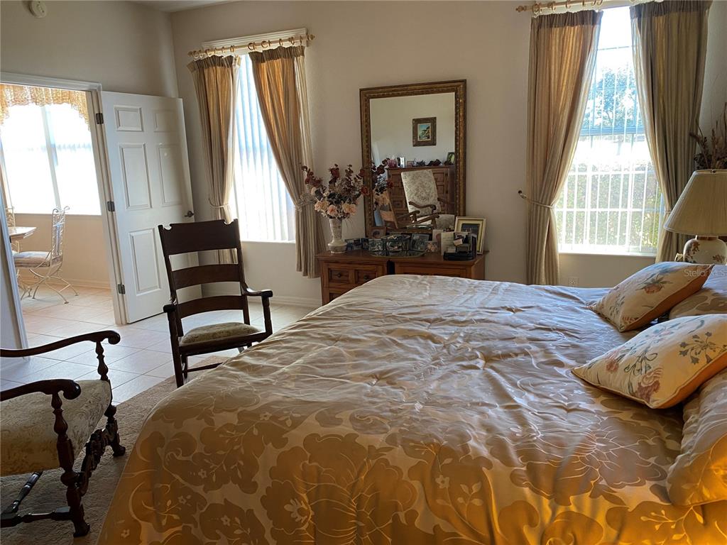 8464 Southwest 82nd Circle Ocala, FL 34481 - Photo 18 of 47 a bedroom with a bed and a large window