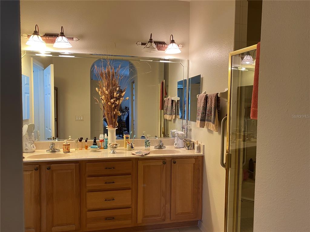 8464 Southwest 82nd Circle Ocala, FL 34481 - Photo 19 of 47 a bathroom with a double vanity sink and a mirror