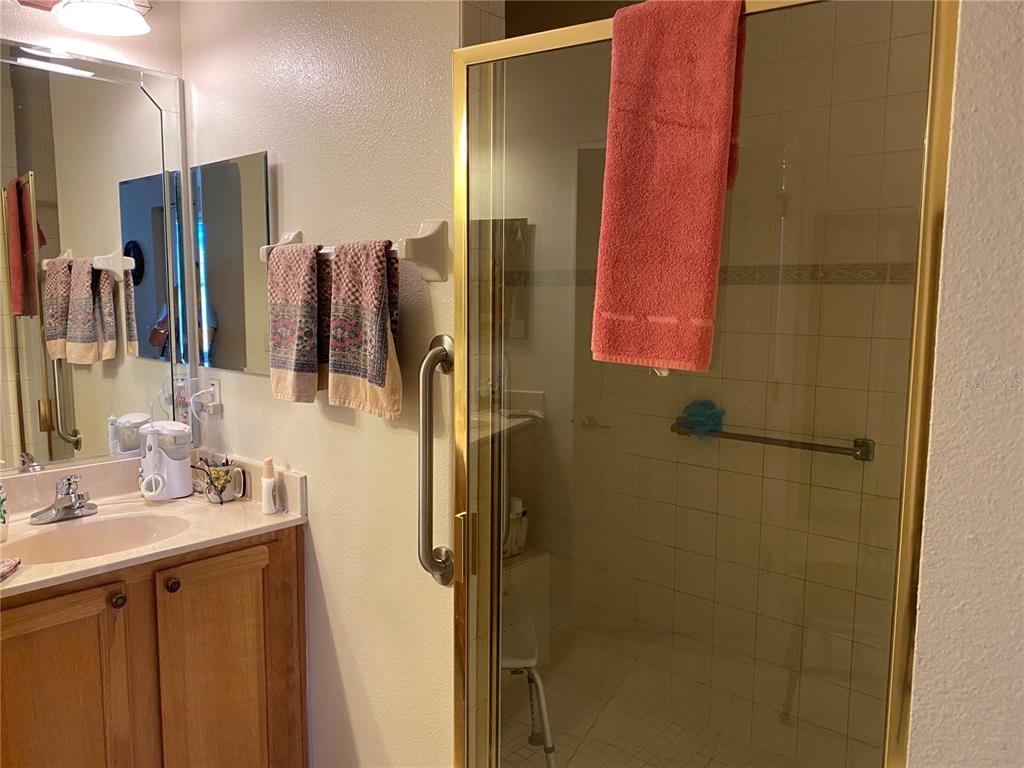 8464 Southwest 82nd Circle Ocala, FL 34481 - Photo 20 of 47 a bathroom with a double vanity sink a vanity and a mirror