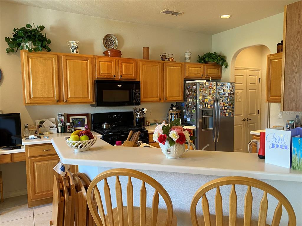 8464 Southwest 82nd Circle Ocala, FL 34481 - Photo 22 of 47 a kitchen with a refrigerator a sink and cabinets