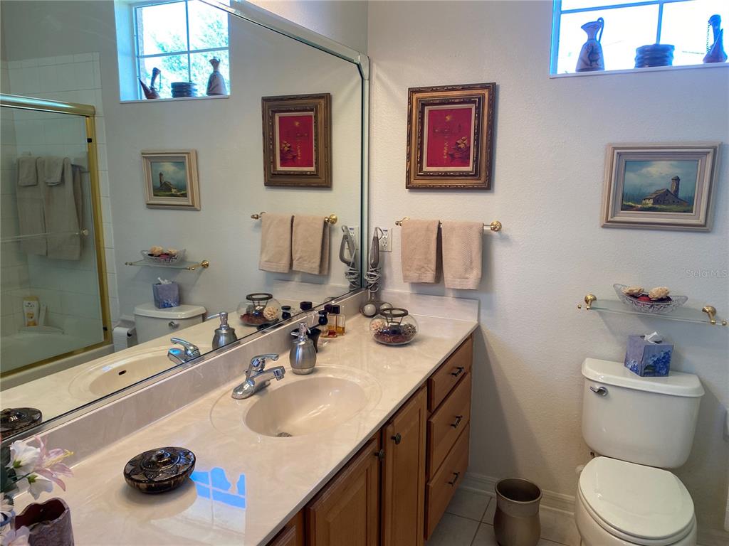 8464 Southwest 82nd Circle Ocala, FL 34481 - Photo 26 of 47 a bathroom with a sink double vanity and a toilet