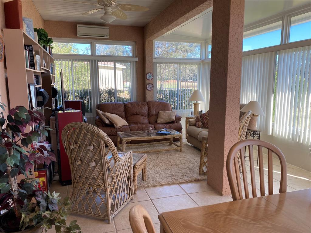 8464 Southwest 82nd Circle Ocala, FL 34481 - Photo 27 of 47 a living room with furniture a fireplace and a large window
