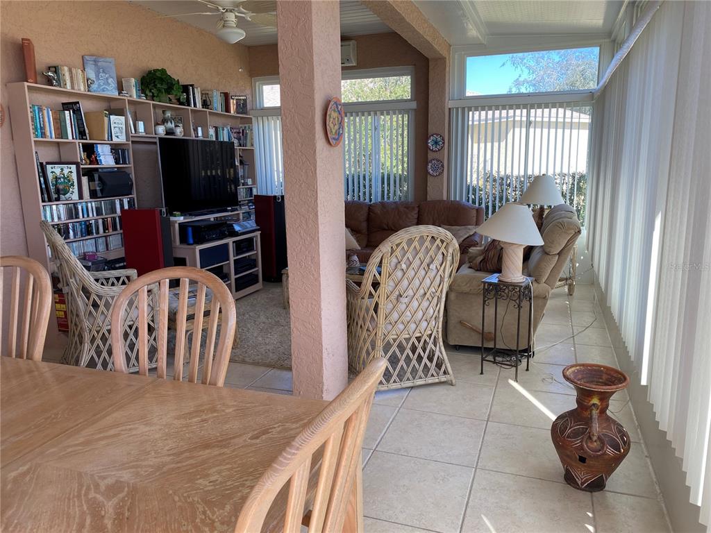 8464 Southwest 82nd Circle Ocala, FL 34481 - Photo 29 of 47 a living room with furniture a flat screen tv and a window