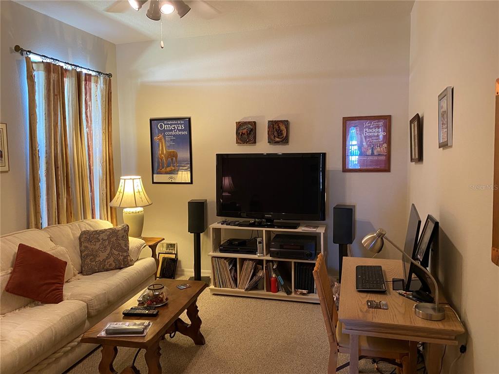 8464 Southwest 82nd Circle Ocala, FL 34481 - Photo 5 of 47 a living room with furniture and a flat screen tv
