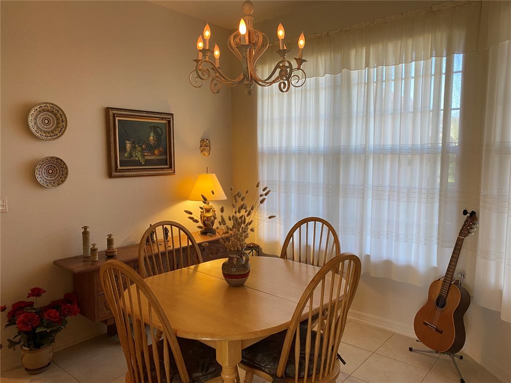 8464 Southwest 82nd Circle Ocala, FL 34481 - Photo 6 of 47 a view of a dining room with furniture and chandelier