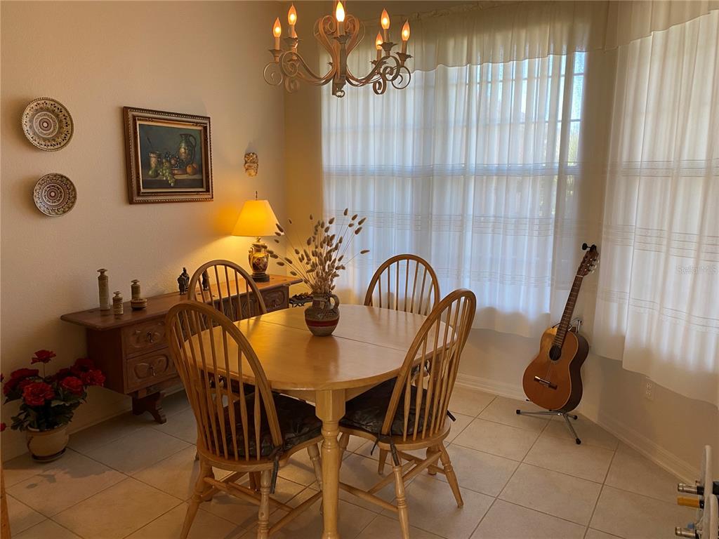 8464 Southwest 82nd Circle Ocala, FL 34481 - Photo 8 of 47 a view of a dining room with furniture and chandelier
