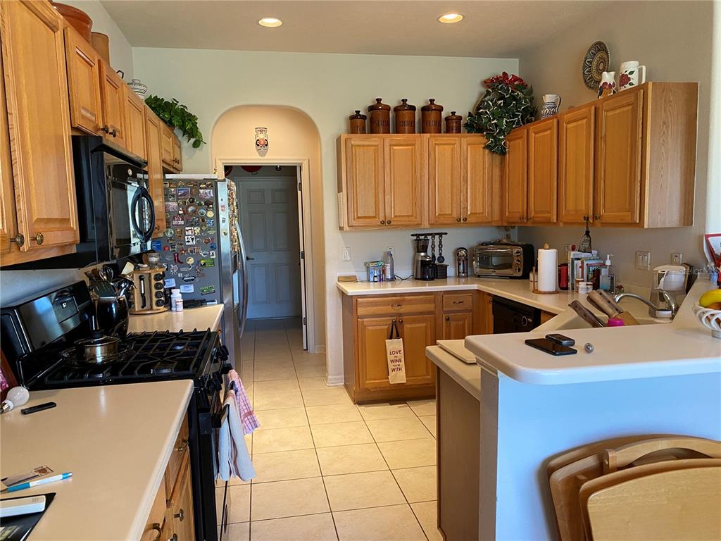 8464 Southwest 82nd Circle Ocala, FL 34481 - Photo 10 of 47 a kitchen that has a sink cabinets and stainless steel appliances